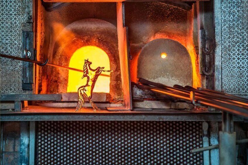 A metalworking furnace with glowing molten metal and a sculpture of a horse. 3