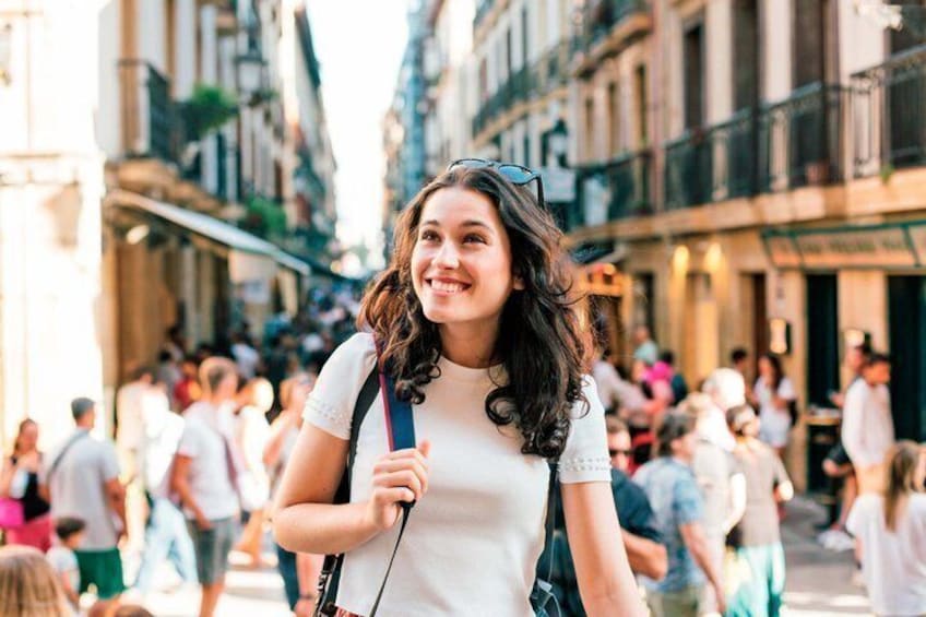 A person walking on a busy street with buildings and pedestrians in the background. 1