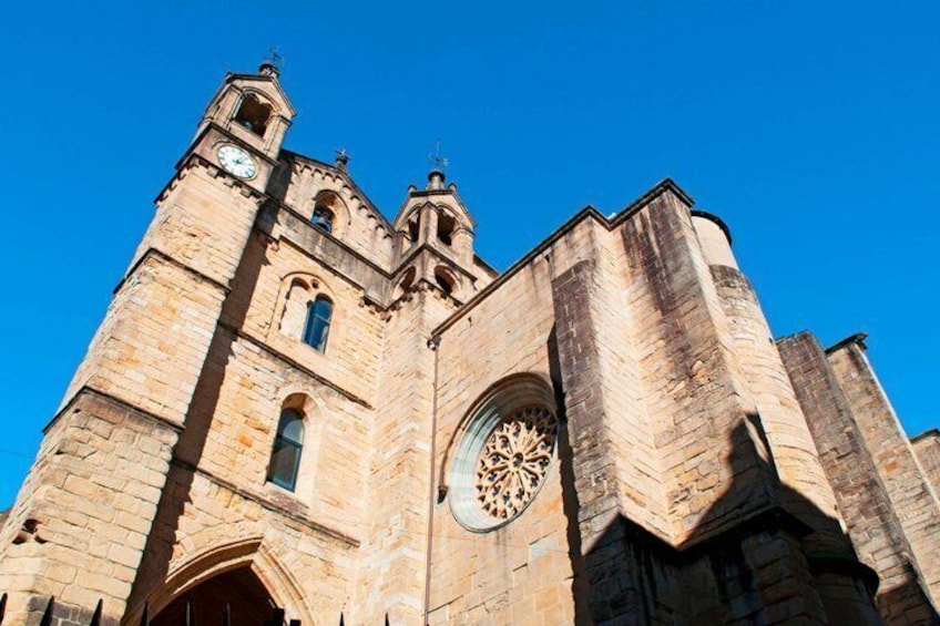 A historic stone church with a large circular window and two towers. 4
