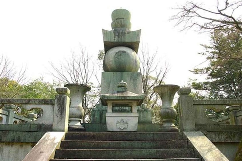 A stone pagoda with a multi-tiered roof, surrounded by a stone balustrade with decorative elements. 2