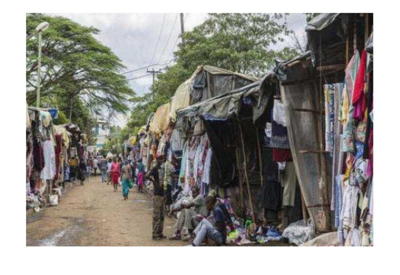 A bustling street market with makeshift stalls and people shopping. 5
