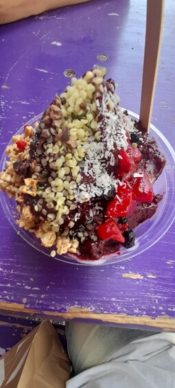 A dessert with various toppings on a purple surface. 5