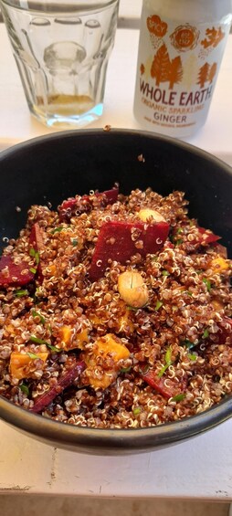 A bowl of quinoa salad with beets and nuts. 3