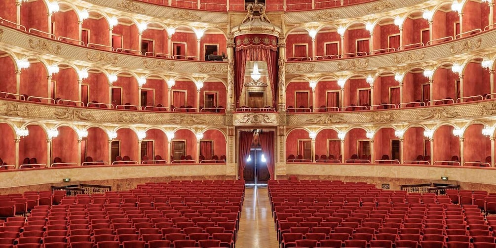 A grand, ornate theater with red seats and intricate architectural details. 5