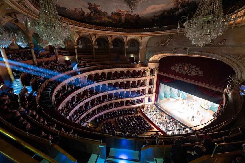A grand theater with ornate architecture, multiple balconies, and a large stage. 2