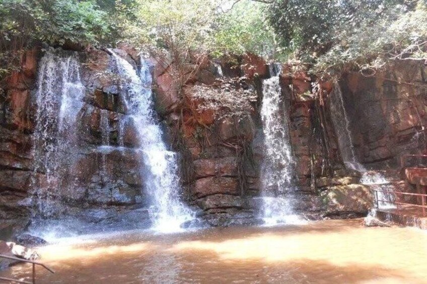 A multi-tiered waterfall with a pool at its base. 5