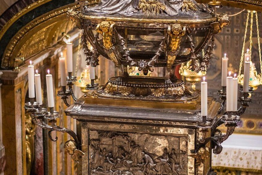 A golden ornate religious altar with lit candles. 3