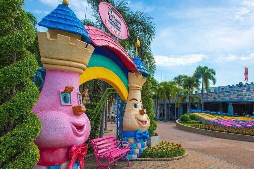A colorful castle entrance with a rainbow archway and a sign that reads 'Disneyland Welcome.' 3
