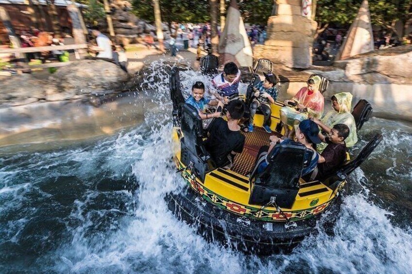 A group of people on a yellow raft navigating through a water channel. 5