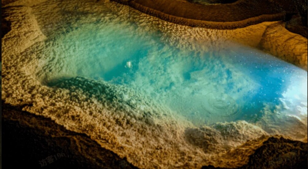 A geothermal pool with mineral deposits and a circular hot spring area. 2