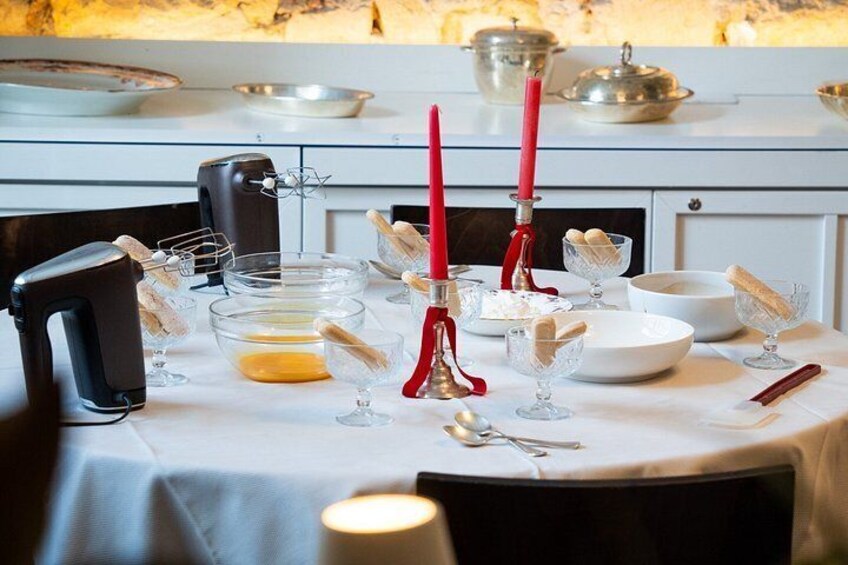 A table set for a meal with various dishes, utensils, and a stand mixer. 2