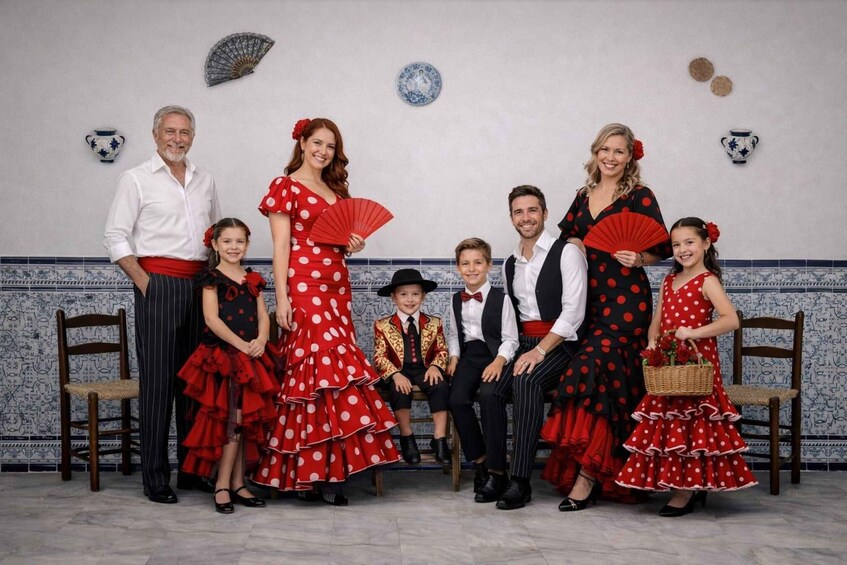 A family dressed in traditional Spanish attire, standing in a room with tiled walls and decorative plates. 2