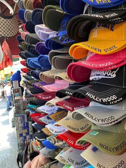 A variety of hats with 'Hollywood' and 'Los Angeles' text, displayed on a rack. 4