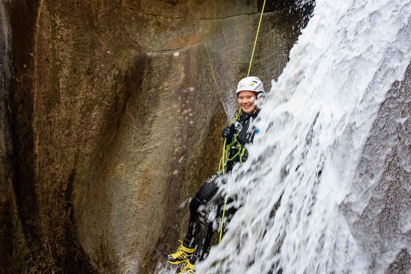 A person rappelling down a waterfall. 3