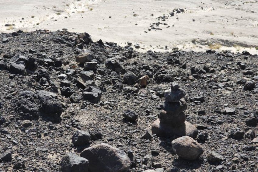 A rocky beach with a stack of stones. 3