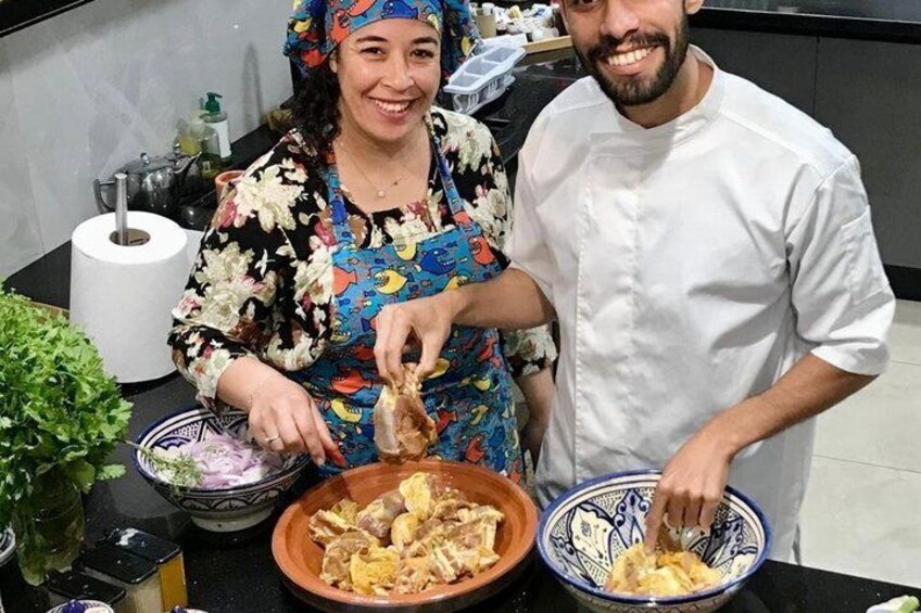 Two people preparing food, with bowls of ingredients and a kitchen counter. 2