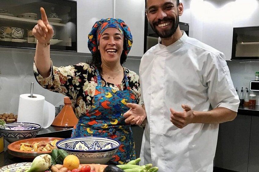 Two people in a kitchen with various dishes and cooking utensils. 3