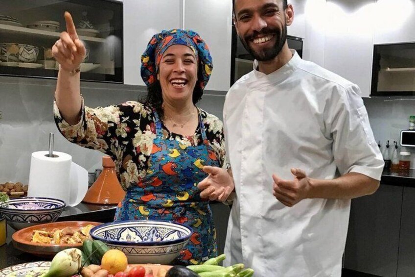 Two people in a kitchen with various dishes and cooking utensils. 3