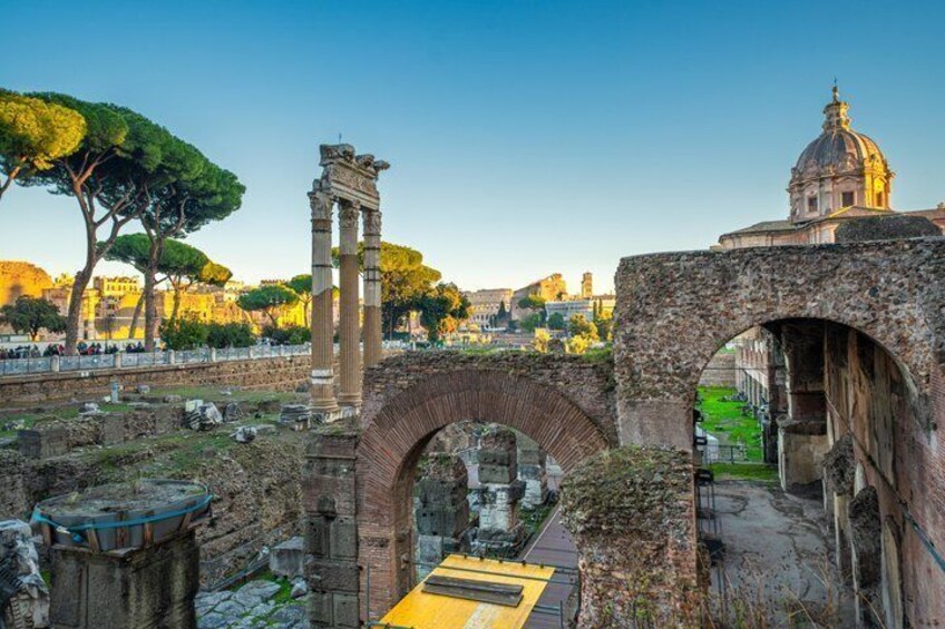 Ancient ruins with columns and arches, a bridge, and a dome structure in the background. 3