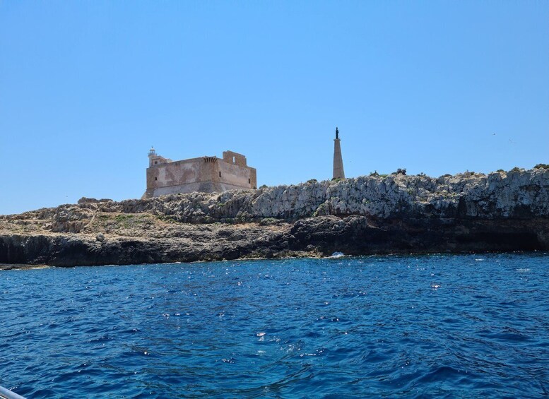 A coastal fortress with a lighthouse on a rocky outcrop, overlooking the sea. 2