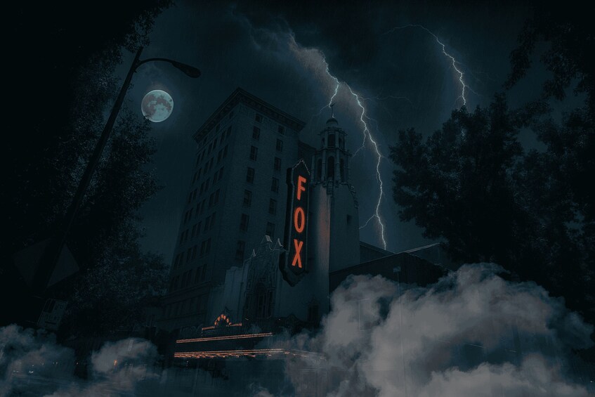 A building with a 'FOX' sign, surrounded by trees and a stormy sky. 1