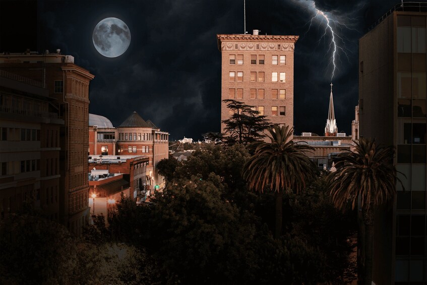 A cityscape at night with a full moon and a lightning strike. 5