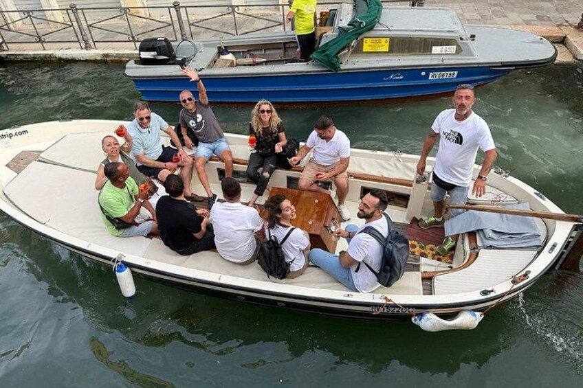A group of people on a small boat with a dock in the background. 2