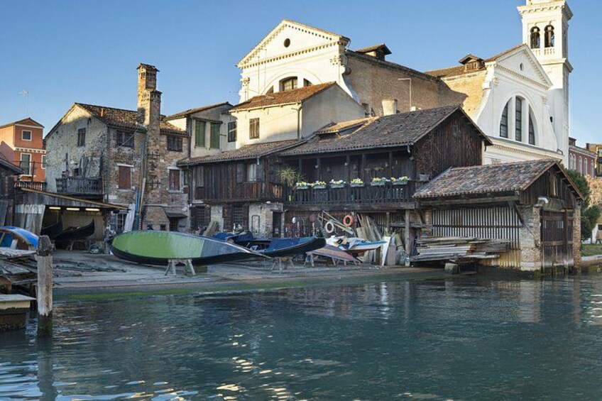 A waterfront with boats, historic buildings, and a church. 3