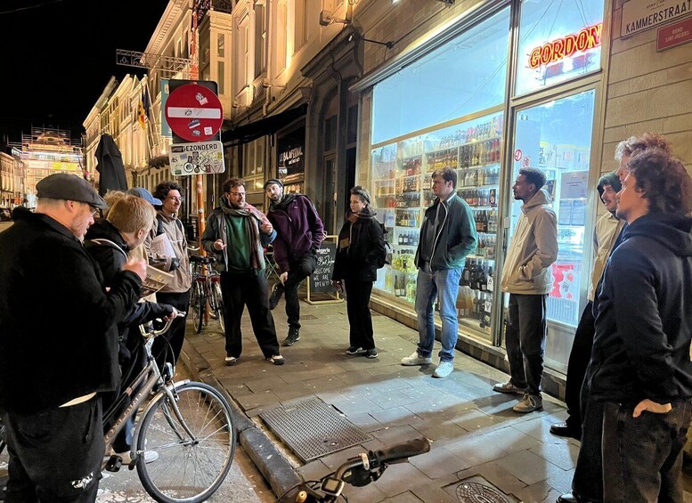 A group of people standing outside a store with a sign that reads 'GORDON' and a no entry sign visible. 3