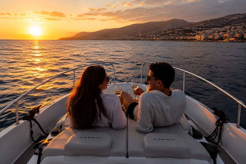 Two people on a boat with a sunset in the background. 5