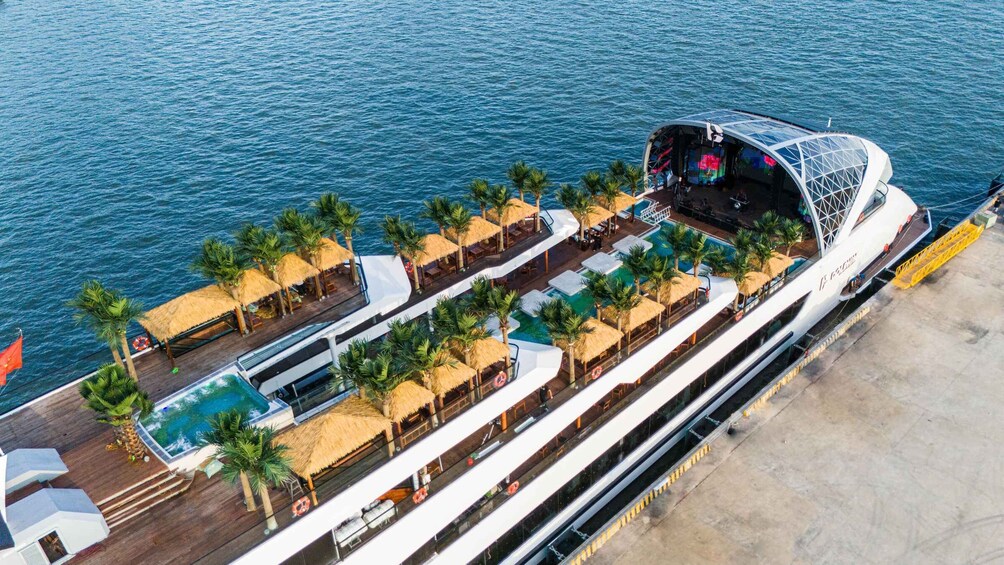 A cruise ship with a stage, outdoor seating, and pools. 3