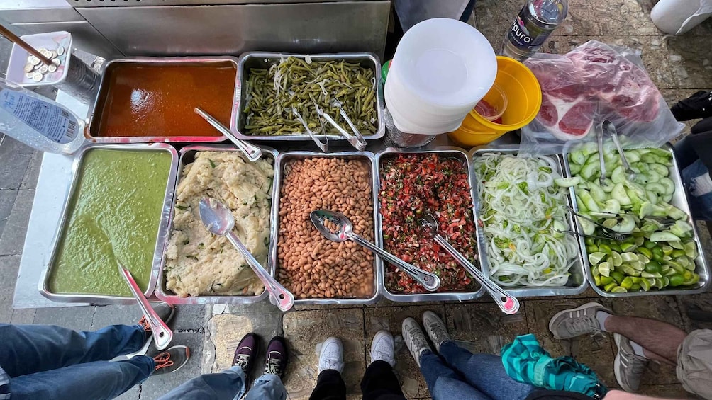 A food stall with various dishes and condiments. 5