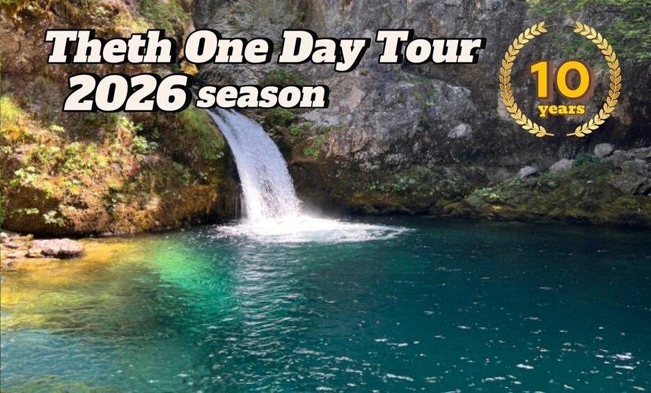 A waterfall with clear water, surrounded by rocky terrain and greenery. 3