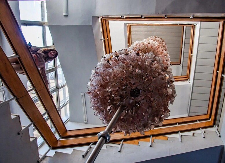 A spiral staircase with a large, intricate sculpture at the top. 2