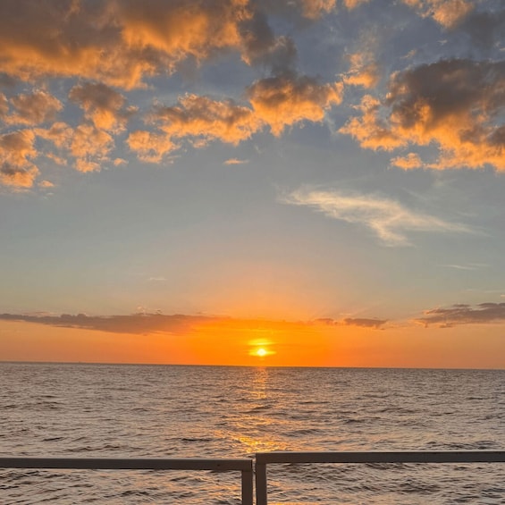 A sunset over the ocean with clouds in the sky. 3