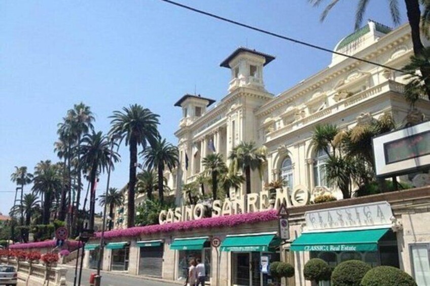 A grand building with 'CASINO SAN REMO' signage, palm trees, and a clear sky. 3
