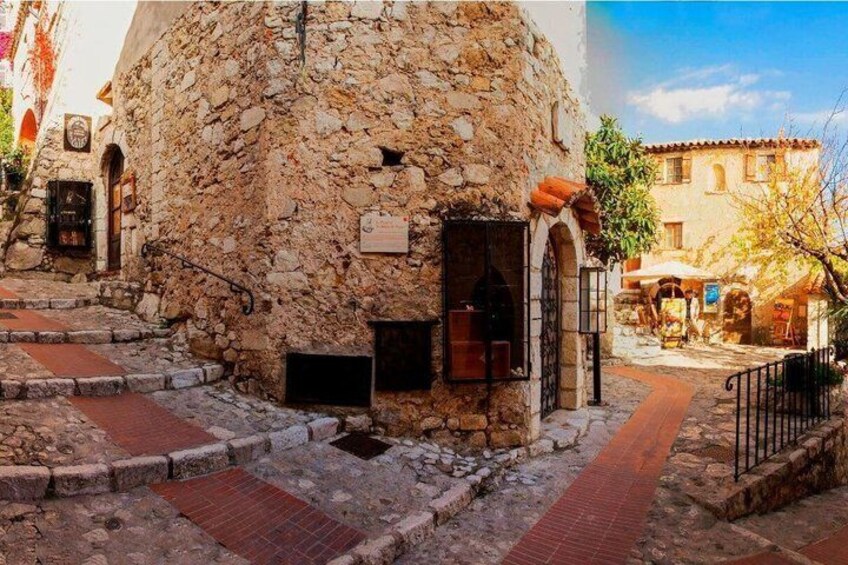 A stone building with a red brick pathway leading to it. 5
