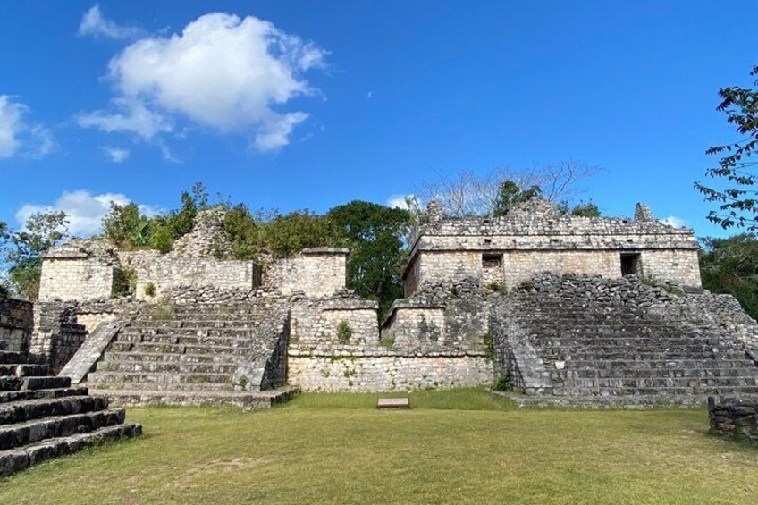 Ancient stone ruins with stepped platforms and a clear blue sky. 2