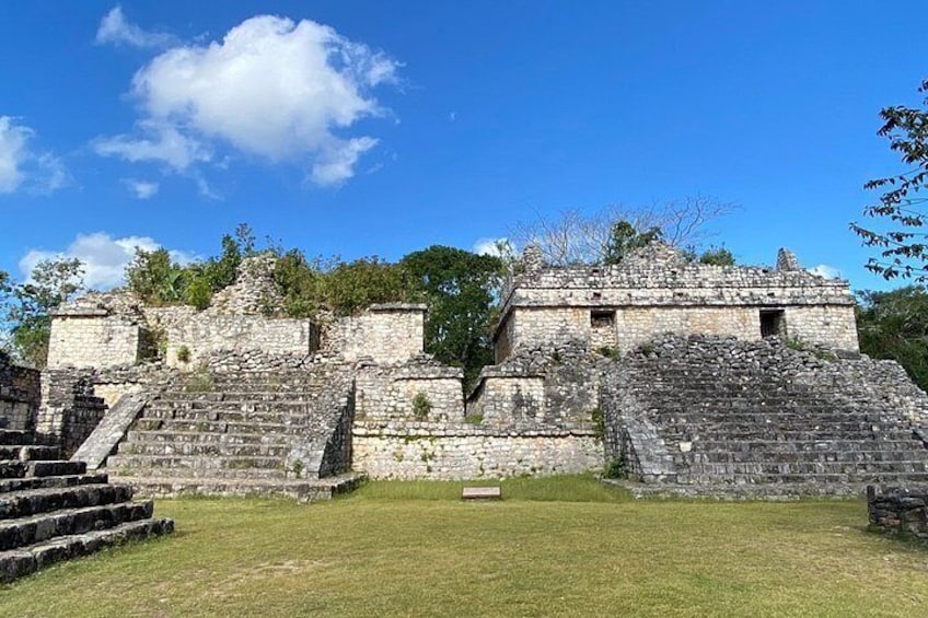 Ancient stone ruins with stepped platforms and a clear blue sky. 2