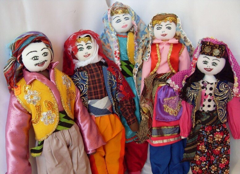 A collection of dolls dressed in colorful traditional attire. 5