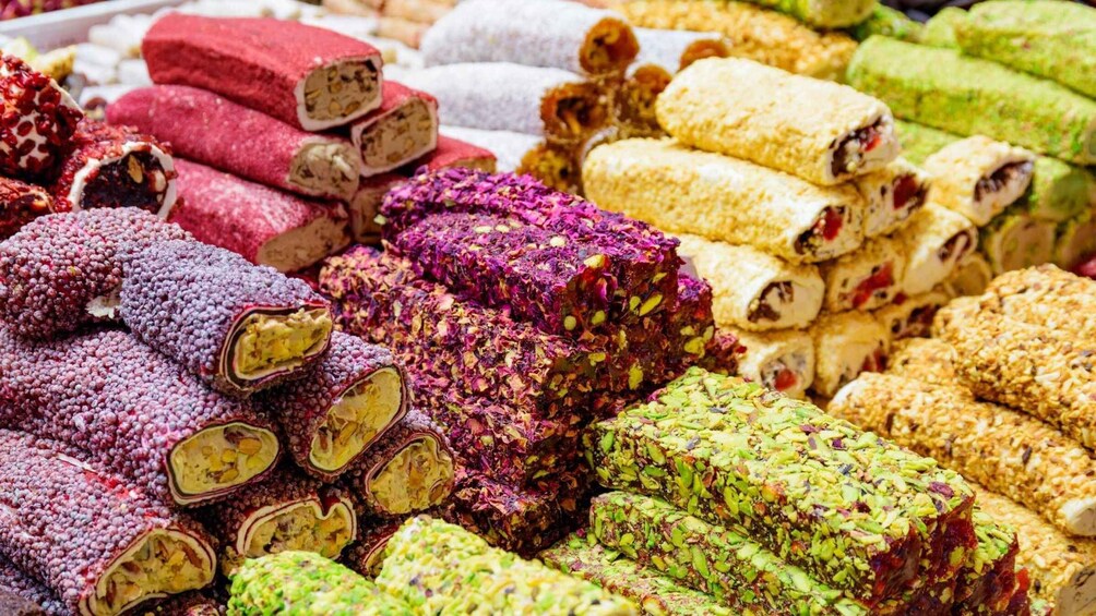 A variety of colorful, rolled pastries with visible nuts and seeds. 2