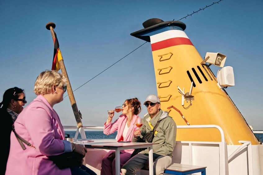 A group of people on a boat with a large, colorful funnel. 2