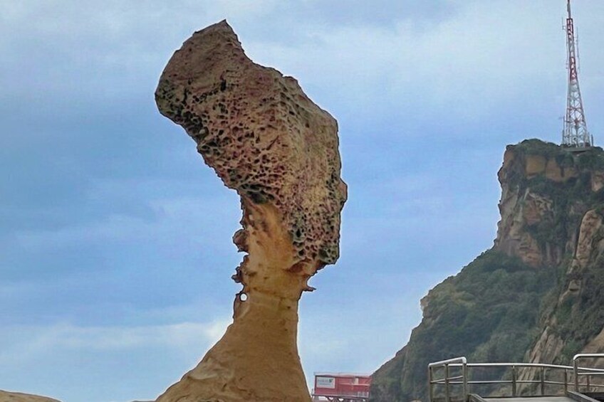 A large rock formation with a radio tower in the background. 4