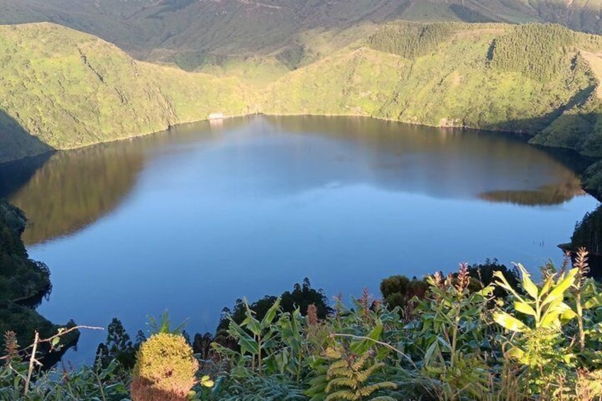 A lake surrounded by green hills. 1