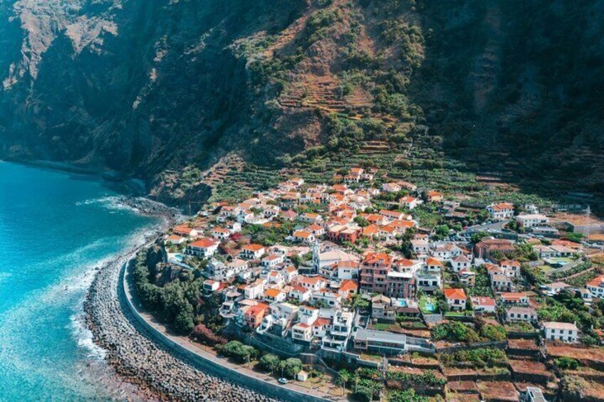 A coastal village with terraced fields and houses along the shoreline. 1
