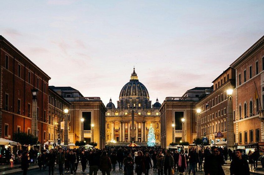 A historic building with a dome, surrounded by a crowd of people. 1