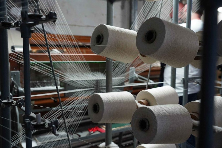 A textile manufacturing facility with machinery and spools of thread. 1