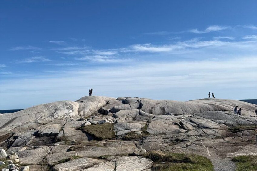A rocky landscape with people hiking. 4