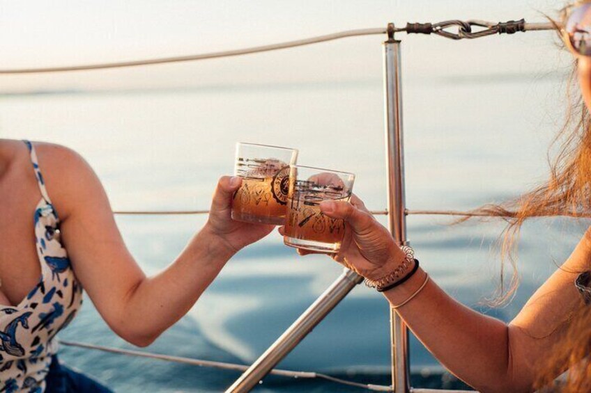 Two people toasting with drinks on a boat. 5