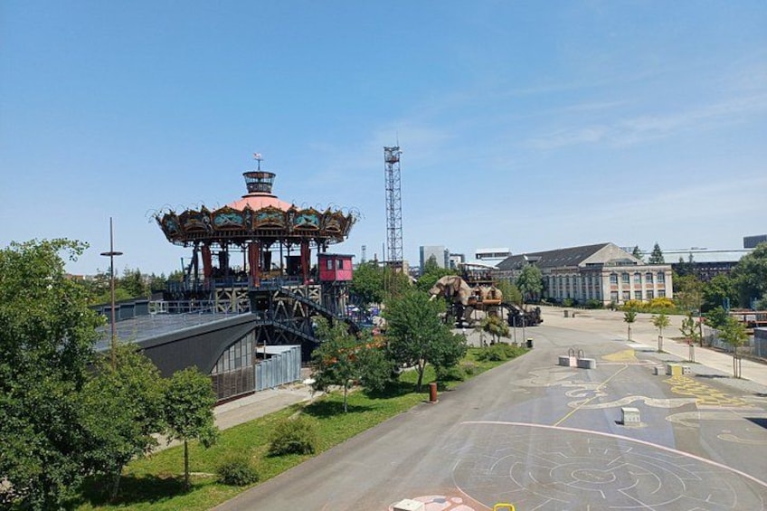 A carousel, a bridge, a building, and a parking lot. 3